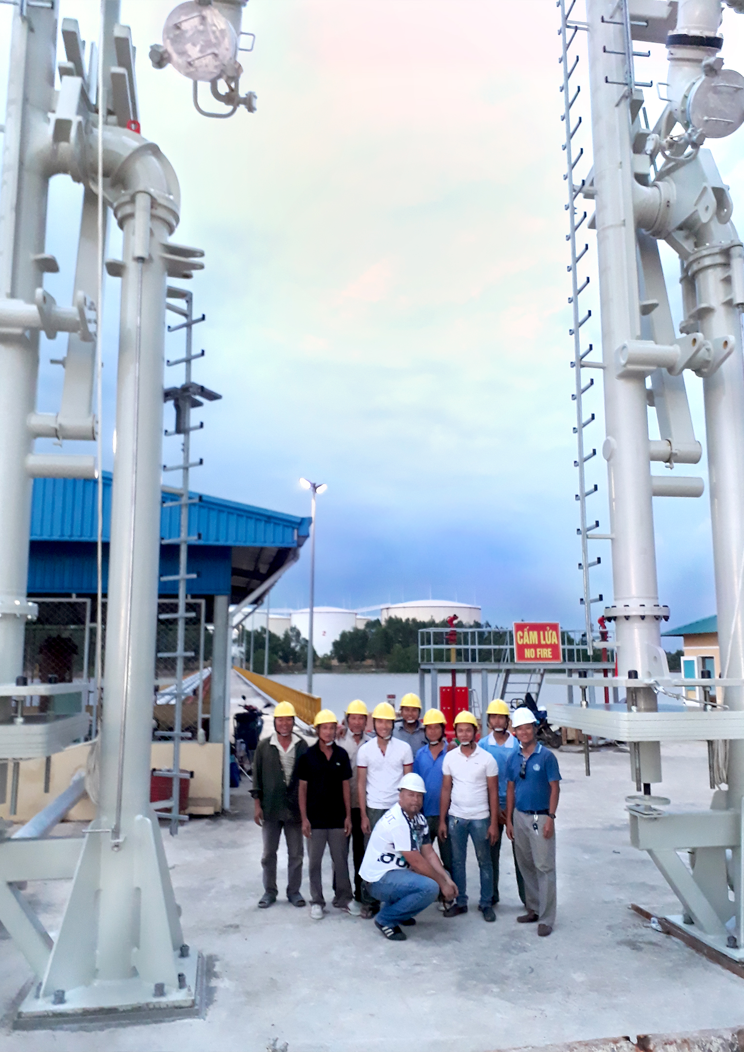 Happy Engineers in front of freshly installed Emco Wheaton Marine Loading Arms